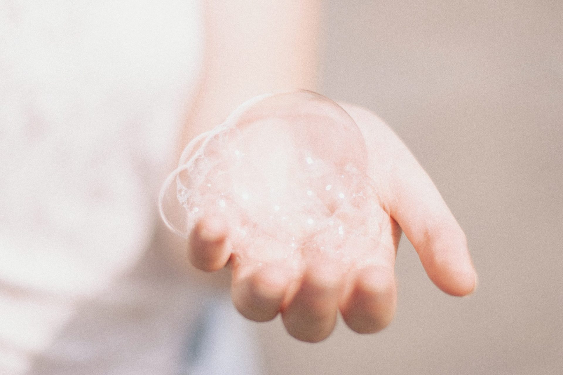 Hands Holding Soap Bubbles