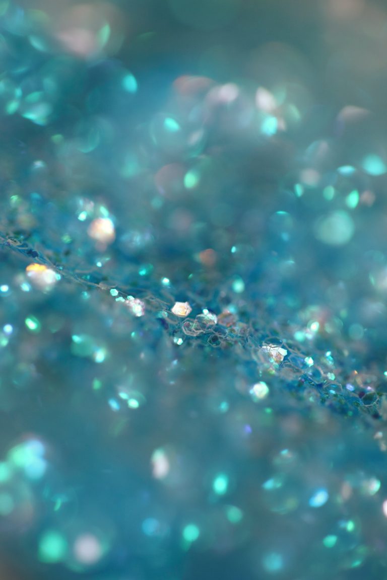 Closeup photograph of blue green mica glitter